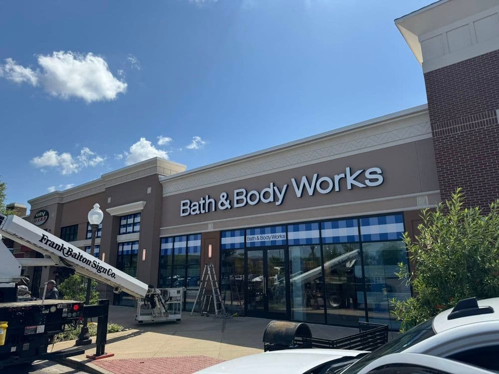 Bath & Body Works storefront featuring clear blue skies and construction equipment nearby.